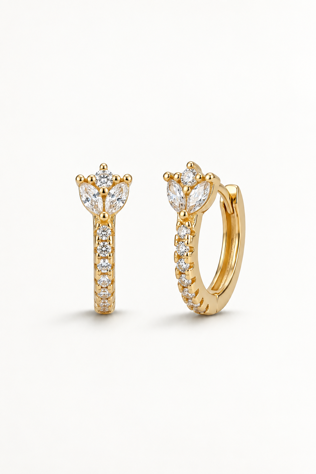 A pair of gold huggie hoop earrings with marquise-cut diamond clusters and pavé-set round diamonds, shown on a clean white background.