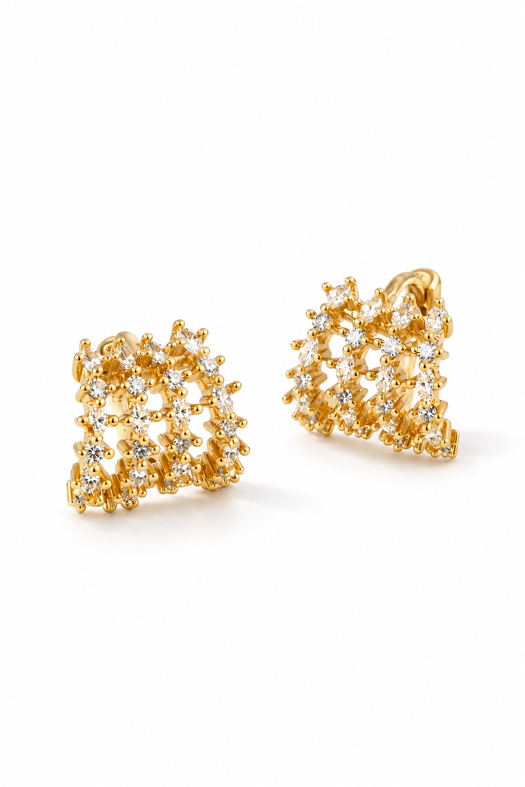 A pair of gold-toned geometric stud earrings adorned with clear pavé gemstones, displayed on a clean white background.